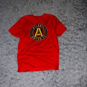 This is a plain red shirt with an Atlanta United symbol soccer